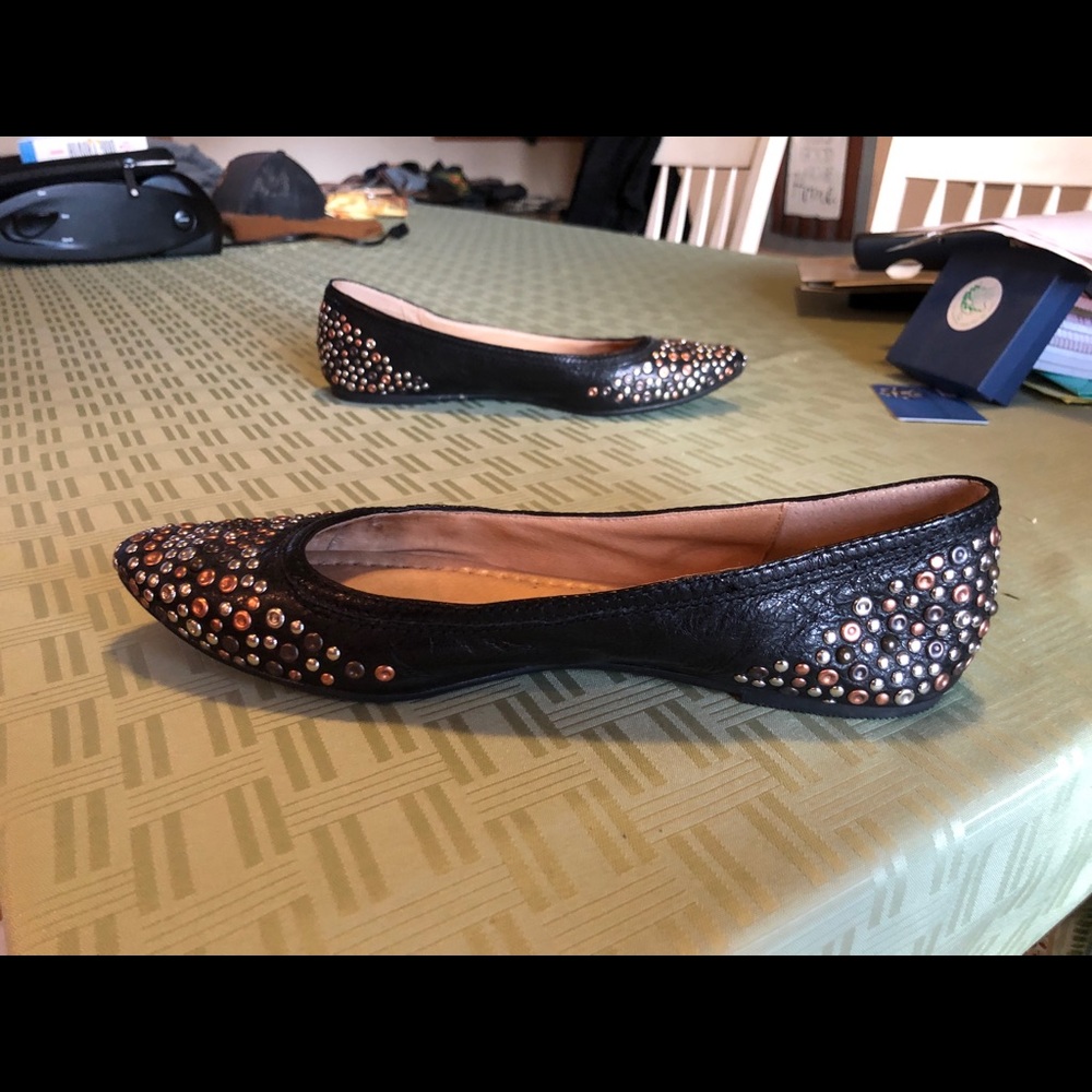 Frye black leather flats with metal grommets